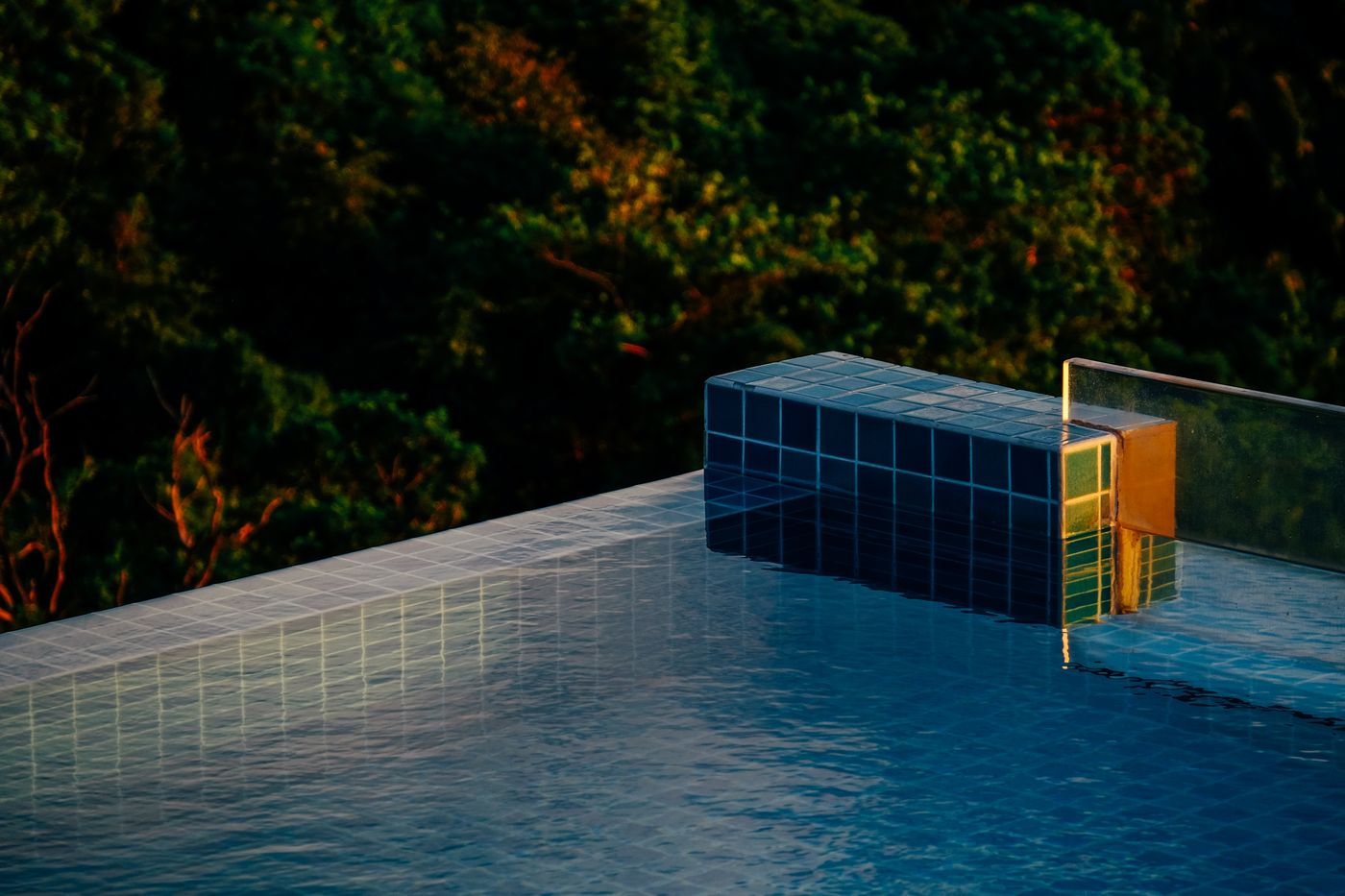 Serene poolside scene with sunset reflections