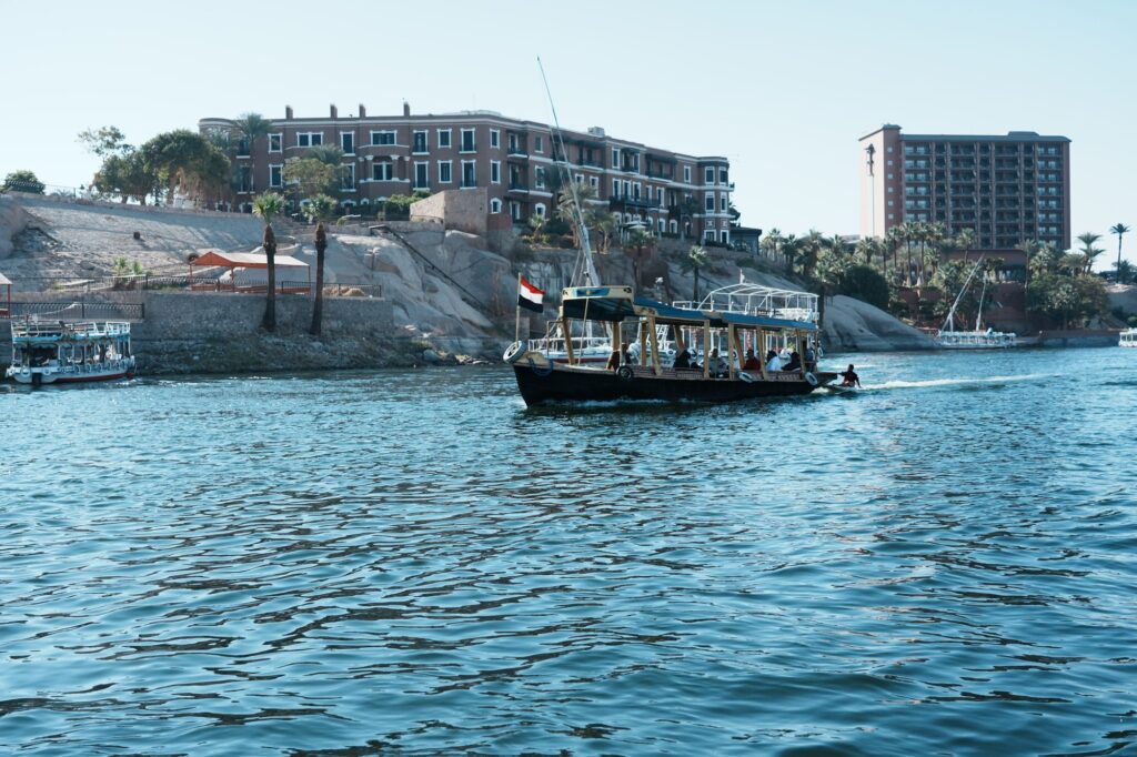 Tour boats on the Nile River with architecture in Aswan, Egypt