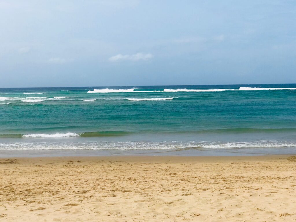 Sandy beach and turquoise waves in Mozambique