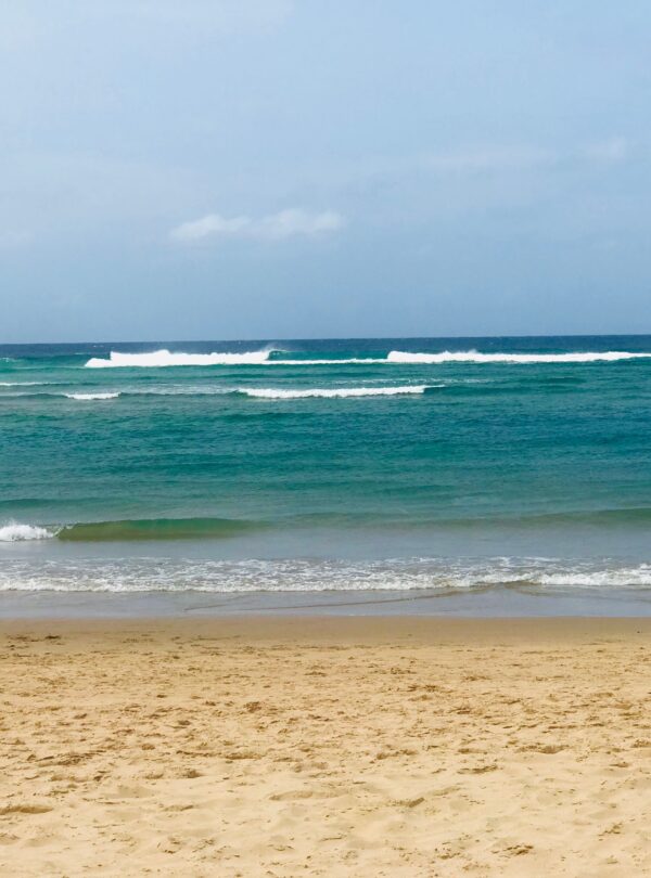 Sandy beach and turquoise waves in Mozambique