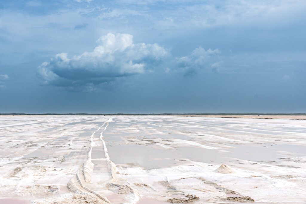 Wide salt flat landscape under blue sky