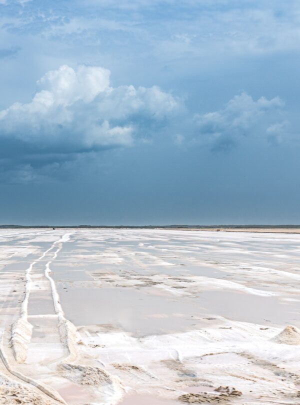 Wide salt flat landscape under blue sky