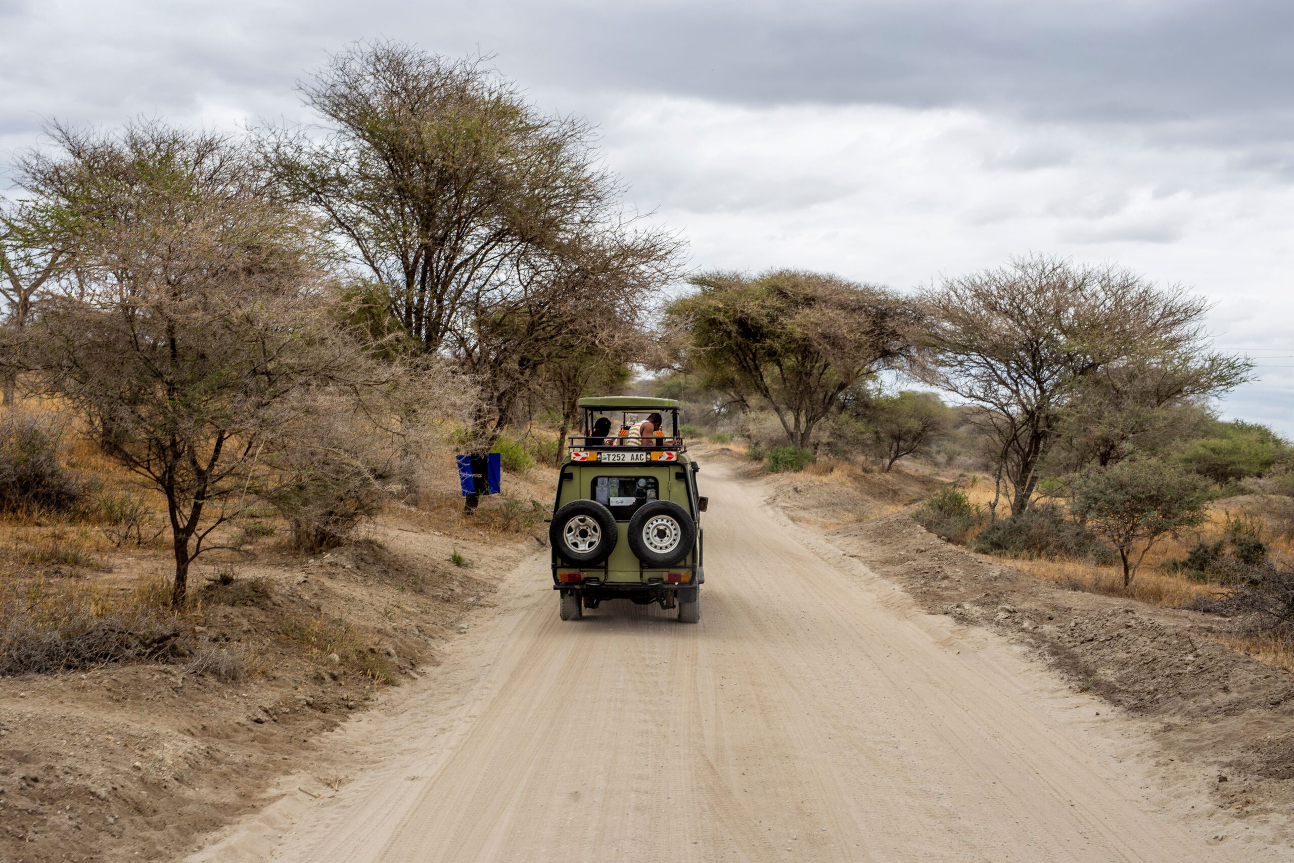Safari jeep on a dusty road in Tanzania
